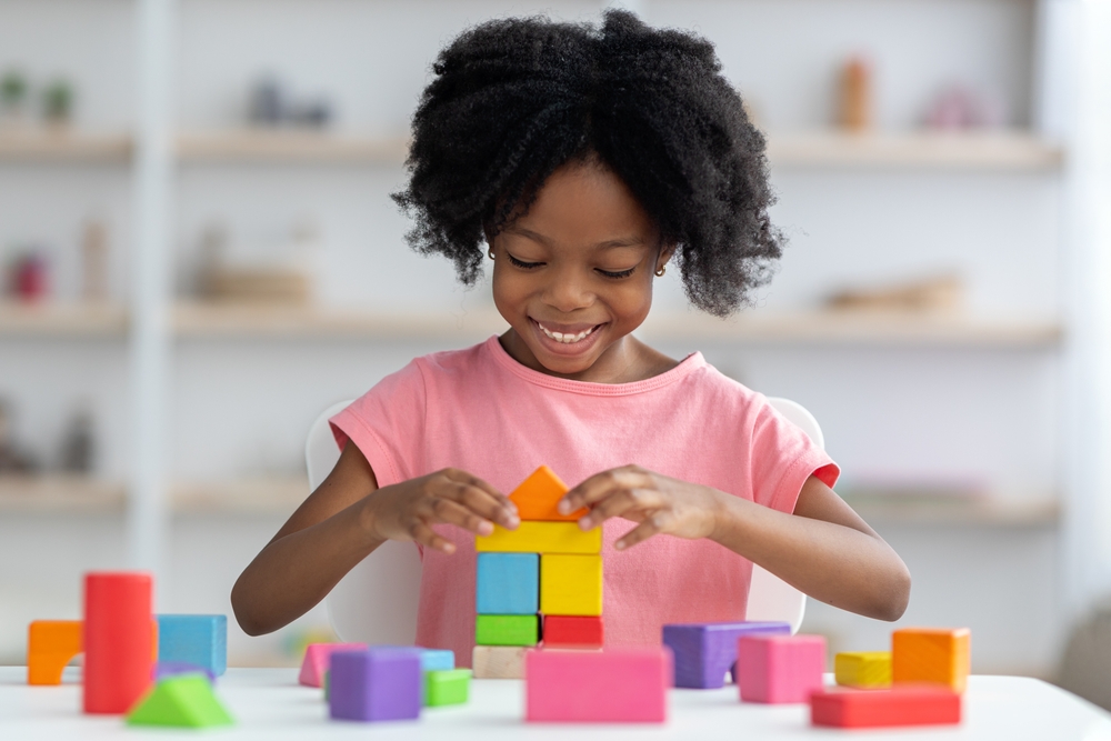 Little,child,happy,african,american,girl,with,bushy,hair,playing