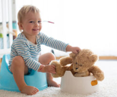 Cute,toddler,boy,,potty,training,,playing,with,his,teddy,bear