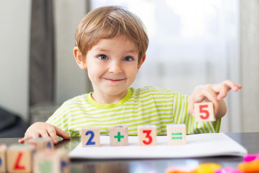 Child,learning,math,with,wooden,blocks